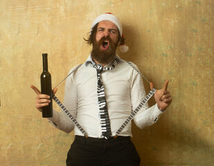 Funny crazy santa. Drunk bad santa holding bottle of whiskey or wine.