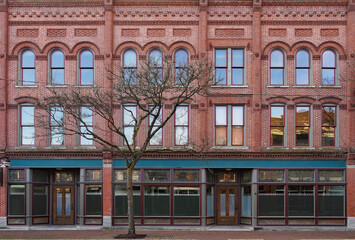 Facade of old fashioned 19th century main street brick commercial building