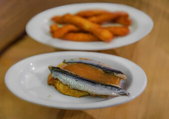 Spanish pintxos anchovies with foie gras in San Sebastian, Basque Country, Spain