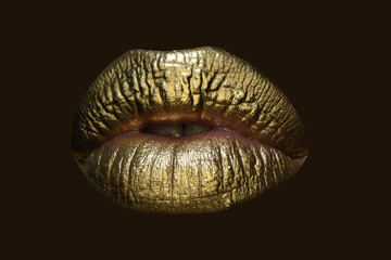 Glamour cosmetic. Golden lipstick on lips, female gold mouth. Imprint lips. Luxury cosmetics for women.