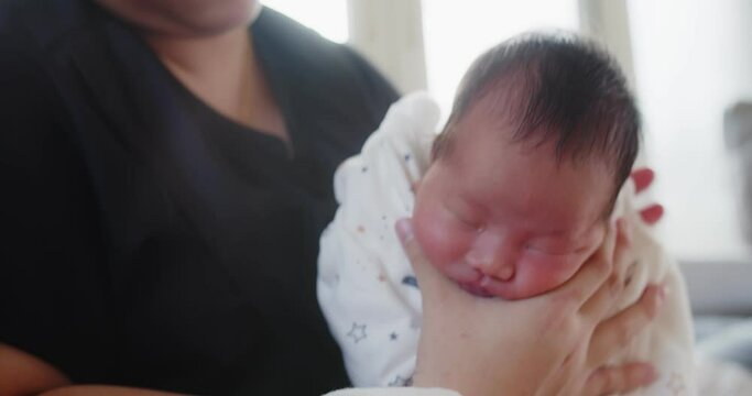 Closeup Lovely Little Newborn Baby Infant Girl In Her Mom Arms Being Burped And Patted Rubbed On The Back Of The Child To Encourage Burping After Eating Full Milk At Home