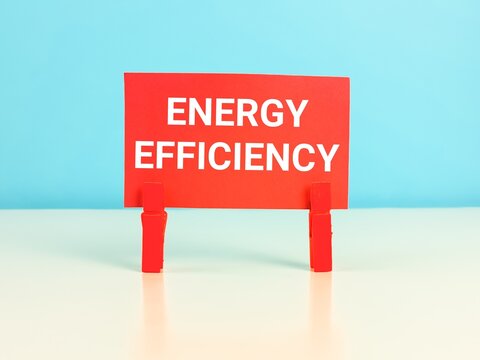 Red paper card written energy efficiency on the table.