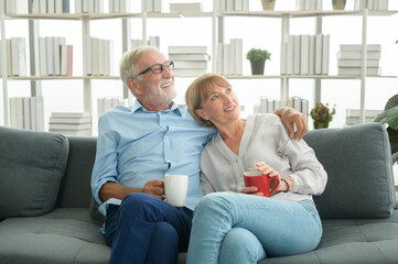 Happy Caucasian seniors couple are drinking coffee in home , relaxing and health care concept .