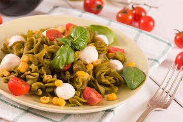Fusilli pasta with cherry tomatoes and sweet corn.