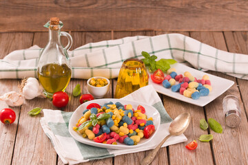 Colored gnocchi with vegetables and sweet corn.