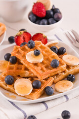 Waffles with blueberries, bananas and honey.