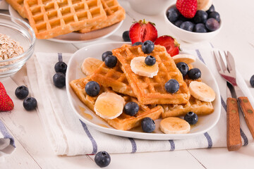 Waffles with blueberries, bananas and honey.