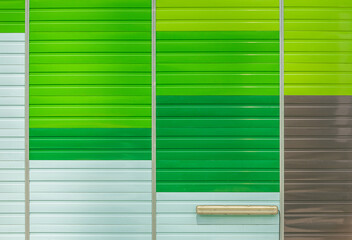 Green and brown striped steel wall with a lamp in texture pattern abstract photography