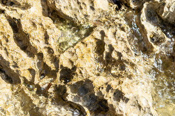 Stone rock and sea wave. Close up.