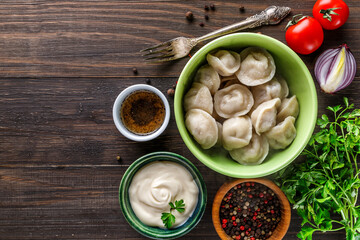 Pierogi or pyrohy, varenyky, vareniki, dumplings served with caramelized salted onion in bowl on wooden table - Traditional russian food- pelmeni, ravioli