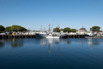Fototapeta na wymiar Boats docked at a commercial fishing harbor