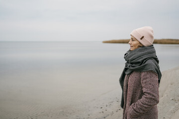 Woman enjoying an invigorating outing to the beach in winter