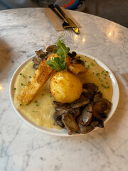 Crispy Eggs served with Potato Puree and and Mushrooms in Breakfast Plate.