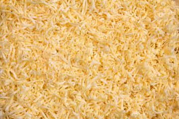 The texture of grated cheese. Orange cheese. Close up