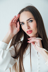 Naklejka premium portrait of a beautiful brunette woman with blue eyes on a white background