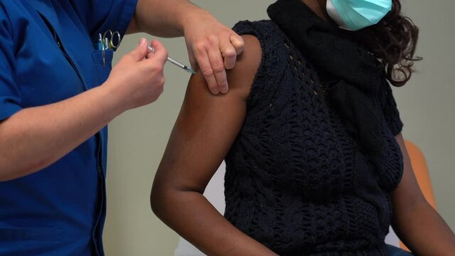 Europe, Italy,  December 2021 - Vaccination against covid-19 Coronavirus epidemic with Pfizer vaccine hospital - black woman child  Omicron variant vaccine - African patient, vaccine on pediatric age 