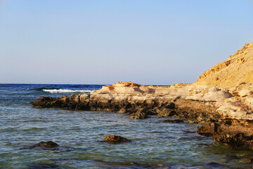 Landscape of sea and mountains in Africa. Sandstone. Rocky seashore. Selective focus.