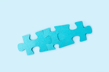 Blue jigsaw puzzle pieces on yellow background. Teamwork  logical thinking. Concept of solutions, mission, success, goals, cooperation and partnership. Copy space for text