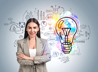 Businesswoman with arms crossed, colourful lightbulb sketch on b