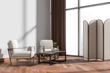 Light waiting room interior with armchairs and coffee table with window
