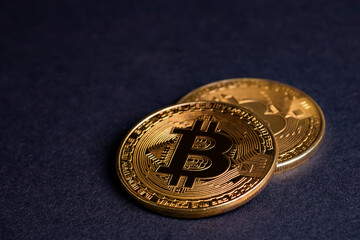 Close up of golden coins with bitcoin symbol background.