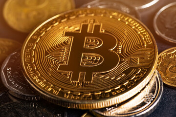 Close up of metal shiny bitcoin crypto currency coin with Ukrainian hryvnia coins. Electronic decentralized money concept. legalise Bitcoin and cryptocurrencies in Ukraine