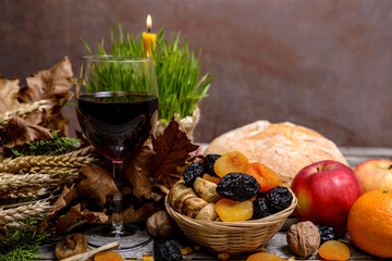 Christmas oak tree, wine, candle, bread and dried fruits