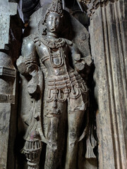 Obraz premium Stock photo of Intricate ruined ancient sculpture of India god or goddess, carved out of black stone in ancient hindu temple, Kopeshwar Mahadev Mandir Khidrapur.
