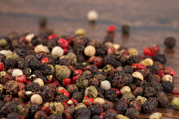 Colored peppers mix on the wooden background