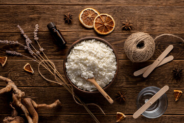 Set for crafting candle on wooden background. Eco soy wax on white table. DIY candle. Hobby concept.