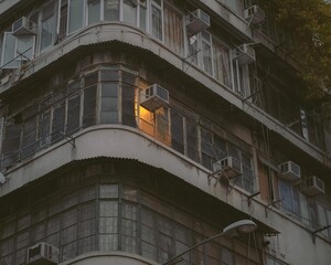 warm light coming out a window of a small apartment