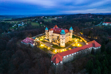 Nowy Wisnicz Castle Illuminated at Christmas Festive, Poland. Drone View - obrazy, fototapety, plakaty