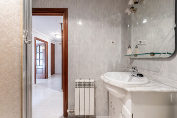 Toilet with marble countertop and white porcelain sink in a vacation rental apartment