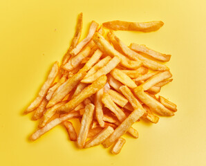  Bunch of french fried potatoes over yellow background