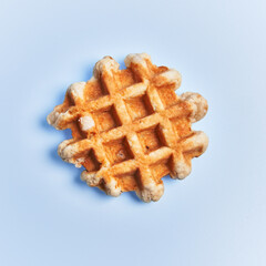  Single delicious waffle over blue background