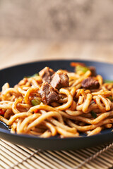  Plate of noodles on a wooden surface