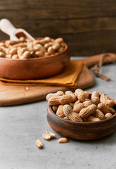 Image of bunch of peanuts in a bowl on a concrete surface