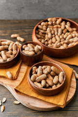 Image of bunch of peanuts in a bowl on a wooden table