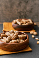 Image of bunch of peanuts in a bowl on a slate surface