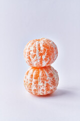  Two peeled tangerines isolated over white background