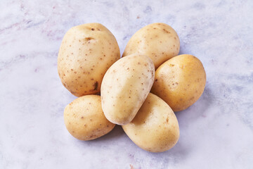 Bunch of potatoes on a marble surface