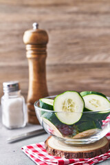  Bowl of slices of cucumber on a marble surface