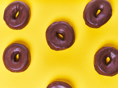  Bunch of chocolate doughnuts on a yellow background