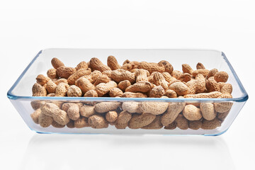  Oven bowl of peanuts with shell isolated on a white background