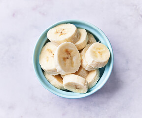  Bowl of slices of banana on a marble table