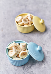  Bowl of slices of banana on a concrete surface