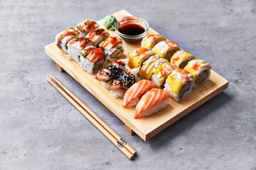  Wooden board of sushi food on a concrete surface