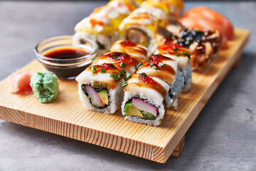  Wooden board of sushi food on a concrete surface