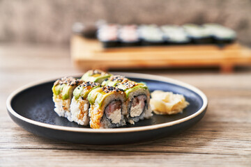  Plate of shrimp and cheese cream uramaki sushi on a wooden surface
