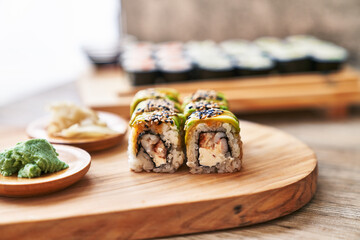  Wooden board of shrimp and cheese cream uramaki sushi on a wooden surface © Krakenimages.com